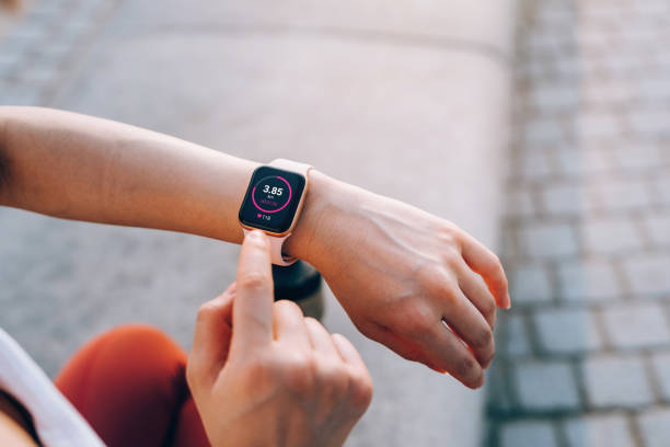 Person checking fitness data on a smartwatch, ideal for the 2024 best fitness trackers selection.